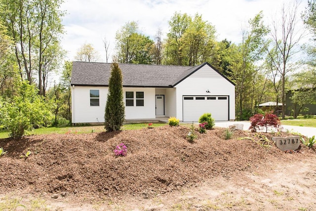 ranch-style house featuring a garage and driveway
