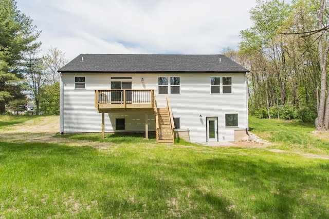 rear view of house featuring stairway, a deck, and a lawn