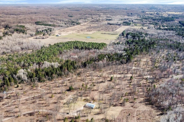 birds eye view of property with a view of trees