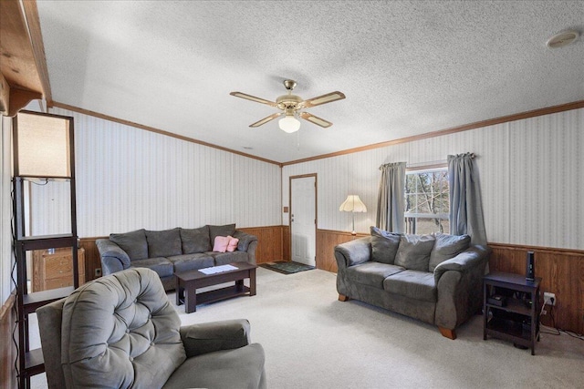 living room featuring wooden walls, ceiling fan, ornamental molding, and wainscoting