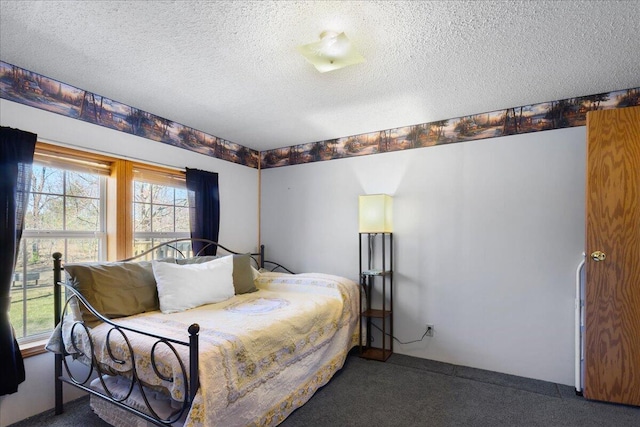 bedroom featuring carpet flooring and a textured ceiling