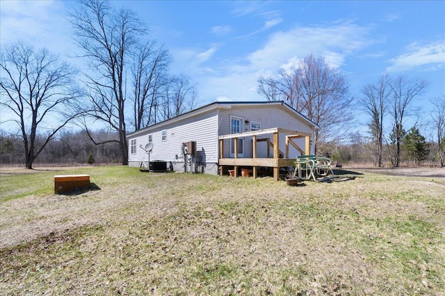 4638 W Mena Creek Xing, White Cloud, MI 49349 - view of home's exterior with a lawn and a wooden deck