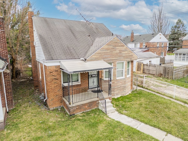14424 Edmore Dr, Detroit, MI 48205 - bungalow with fence, a porch, a front yard, brick siding, and roof with shingles