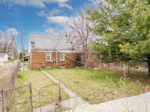 14424 Edmore Dr, Detroit, MI 48205 - back of property with a lawn, a gate, brick siding, and fence private yard