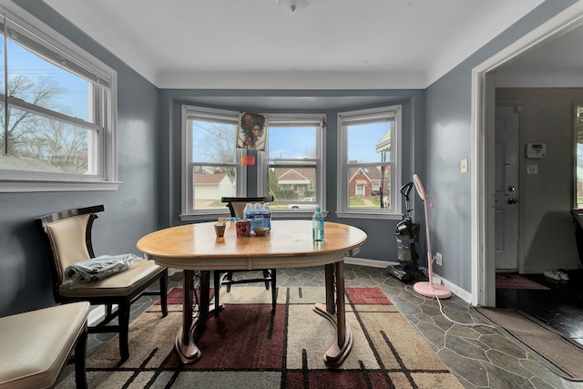 14424 Edmore Dr, Detroit, MI 48205 - dining space featuring stone finish floor, a healthy amount of sunlight, and baseboards