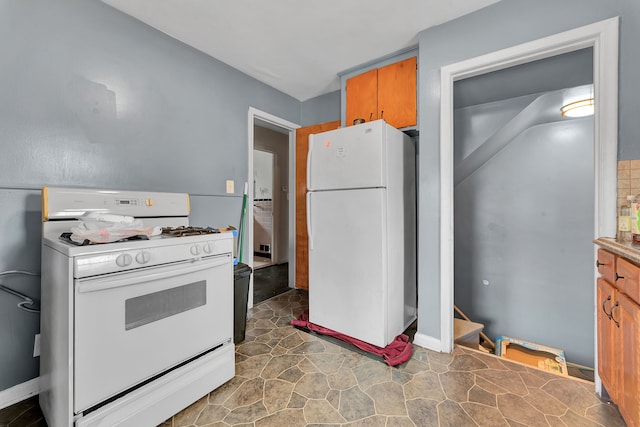 14424 Edmore Dr, Detroit, MI 48205 - kitchen featuring white appliances, stone finish floor, and brown cabinets