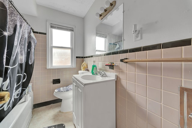 14424 Edmore Dr, Detroit, MI 48205 - full bathroom with shower / bath combo, toilet, tile walls, wainscoting, and vanity