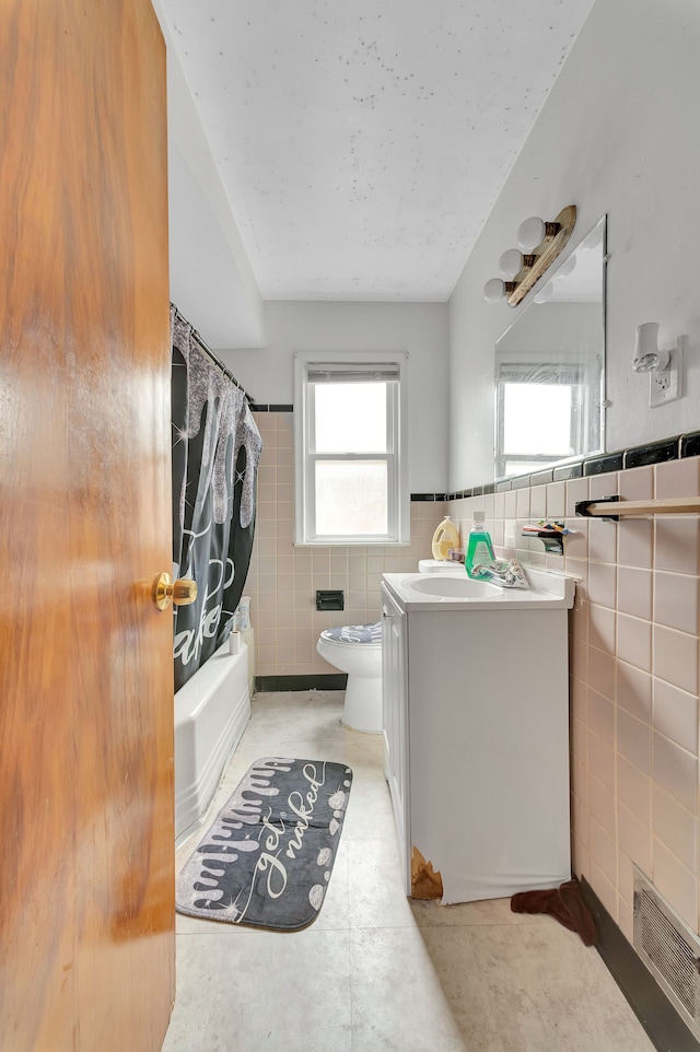 14424 Edmore Dr, Detroit, MI 48205 - full bath with plenty of natural light, vanity, shower / tub combo with curtain, tile walls, and toilet