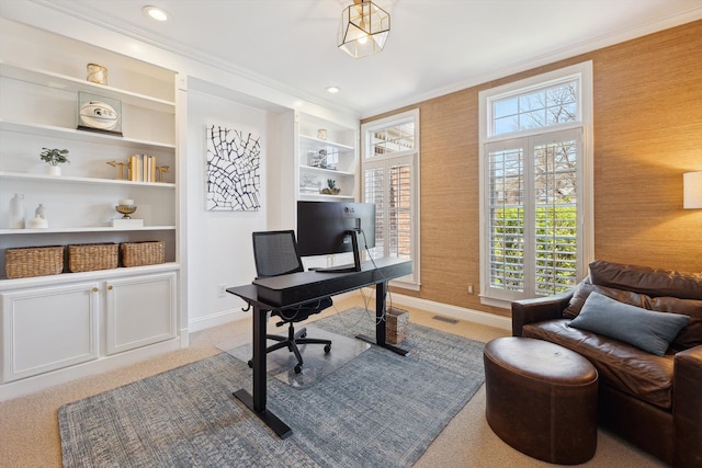 office space with baseboards, ornamental molding, visible vents, and a wealth of natural light