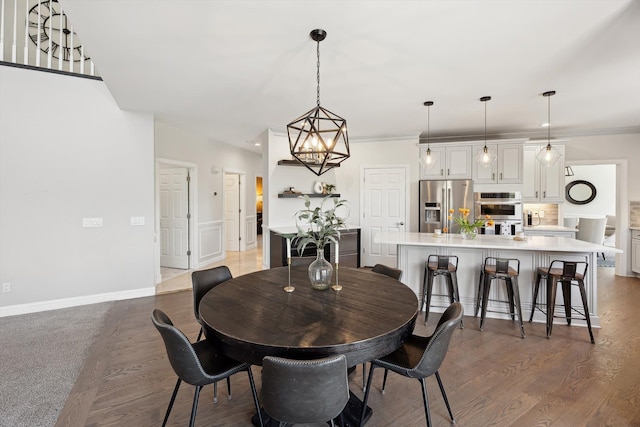 dining area with baseboards and wood finished floors
