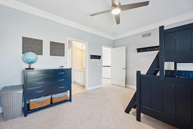 bedroom with light colored carpet, crown molding, visible vents, baseboards, and ensuite bathroom
