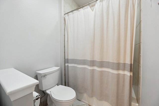 bathroom with shower / bath combo and toilet