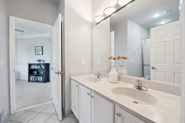 full bathroom featuring crown molding, double vanity, visible vents, and a sink