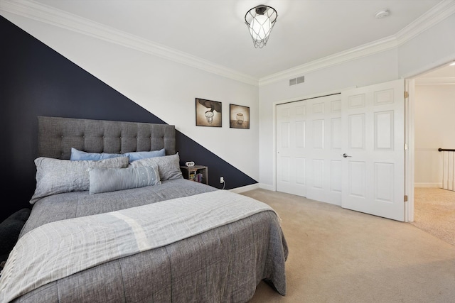 bedroom featuring carpet floors, ornamental molding, a closet, and visible vents