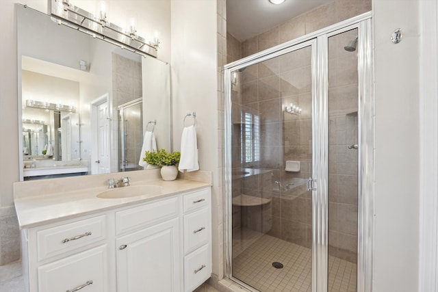 full bathroom with vanity and a stall shower