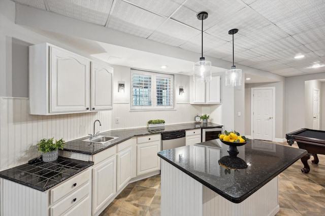 kitchen with a center island, white cabinetry, a sink, dishwasher, and decorative light fixtures