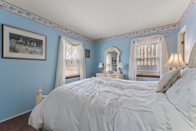 bedroom featuring baseboards and carpet flooring