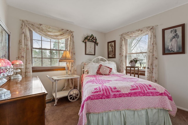 bedroom with baseboards, carpet flooring, and multiple windows