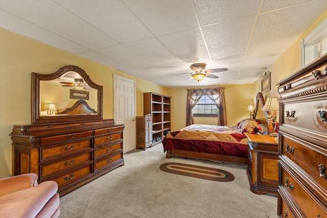 carpeted bedroom featuring a paneled ceiling and ceiling fan
