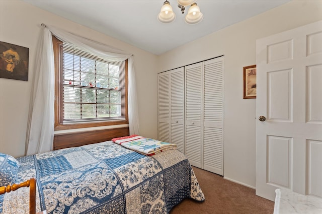 carpeted bedroom featuring a chandelier and a closet