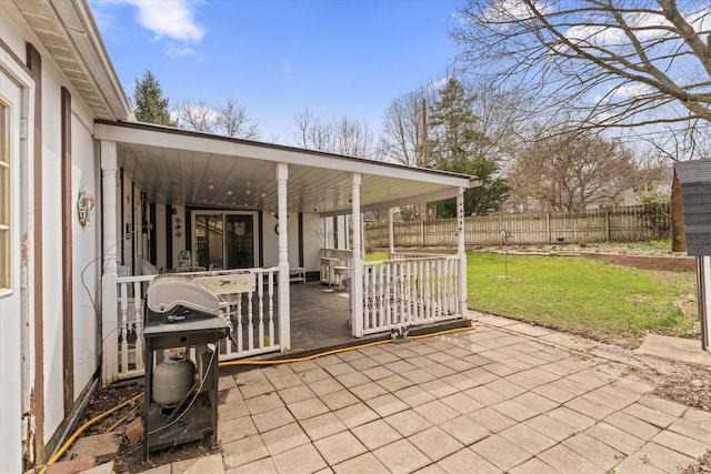 view of patio / terrace with a grill, a porch, and fence