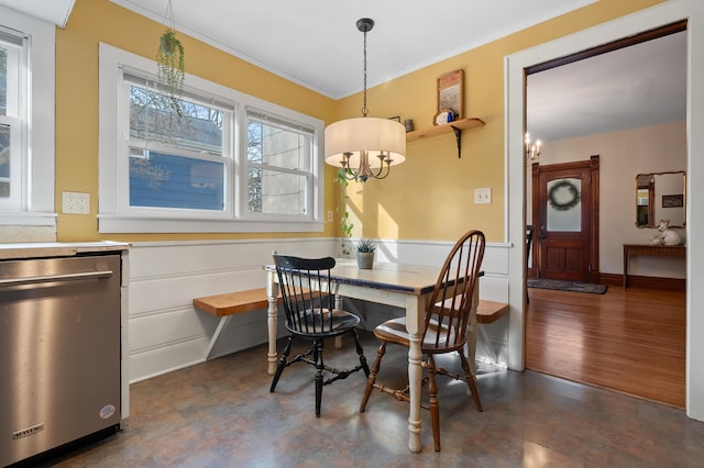 265 Bailey Ave, South Haven, MI 49090 - dining space featuring a chandelier, crown molding, and a wainscoted wall