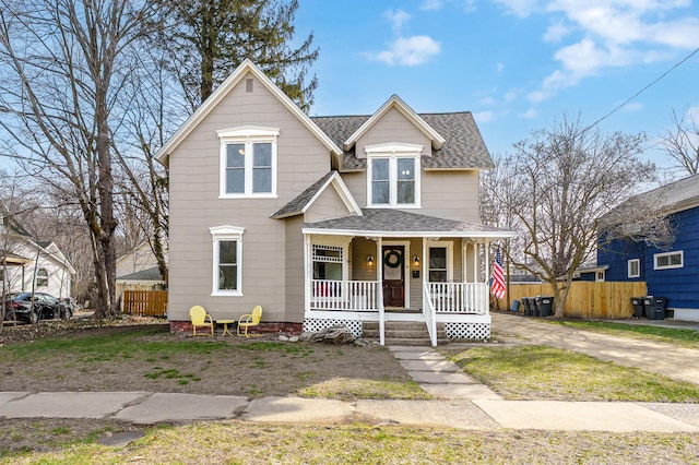 265 Bailey Ave, South Haven, MI 49090 - view of front of house featuring fence, a shingled roof, and covered porch