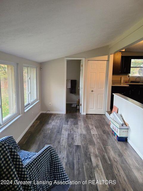 17669 Lake Dr, Barryton, MI 49305 - unfurnished living room featuring dark wood finished floors and baseboards