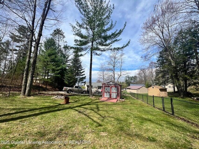 17669 Lake Dr, Barryton, MI 49305 - view of yard featuring a storage unit and an outbuilding