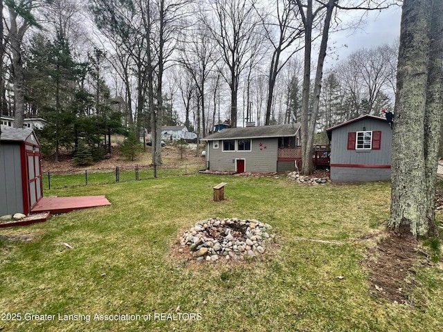17669 Lake Dr, Barryton, MI 49305 - view of yard with an outdoor structure, an outdoor fire pit, and a storage shed