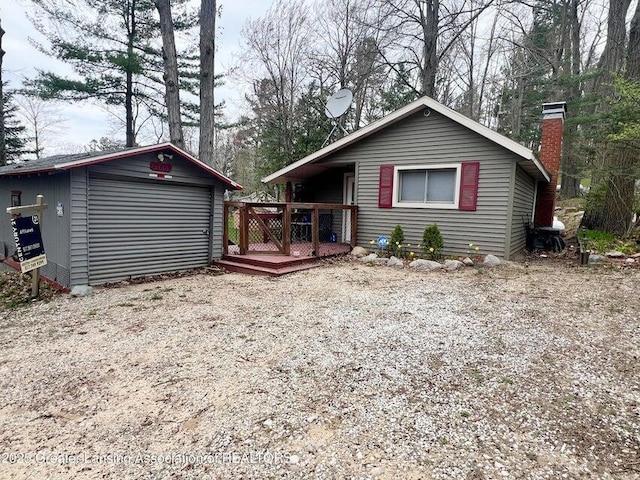 17669 Lake Dr, Barryton, MI 49305 - view of front of property with a deck, an outbuilding, and a chimney