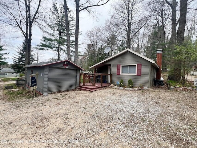 17669 Lake Dr, Barryton, MI 49305 - ranch-style house with a deck, an outbuilding, and a chimney