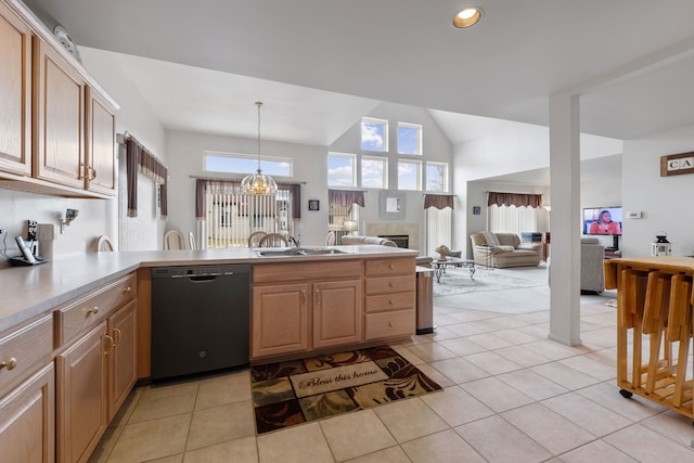 kitchen with dishwasher, a peninsula, a healthy amount of sunlight, and a fireplace