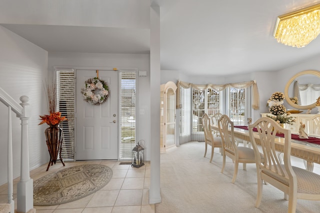 entryway with baseboards, tile patterned flooring, and a notable chandelier