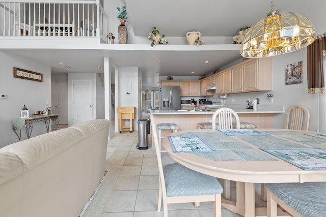 dining room with light tile patterned flooring, a notable chandelier, and recessed lighting