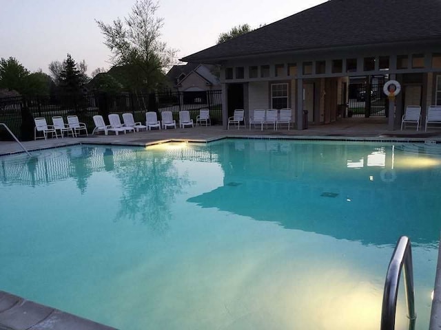 pool featuring fence and a patio area