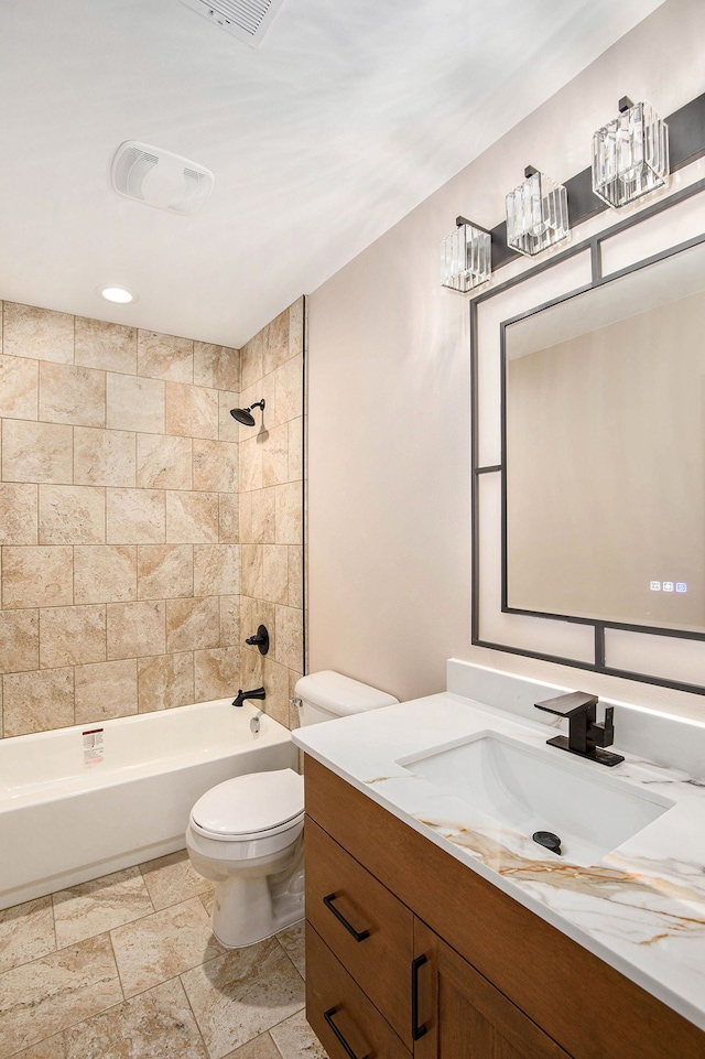 bathroom featuring vanity, bathtub / shower combination, stone tile flooring, toilet, and visible vents