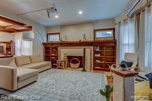 living area with a tiled fireplace, recessed lighting, and a wealth of natural light
