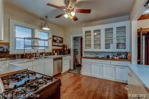 kitchen with white cabinets, ceiling fan, range with gas cooktop, and dishwasher