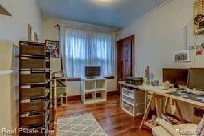 office area with crown molding and wood finished floors