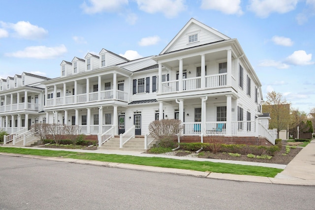 townhome / multi-family property featuring covered porch and a balcony