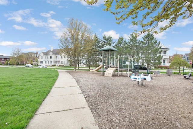 community jungle gym featuring a residential view and a yard