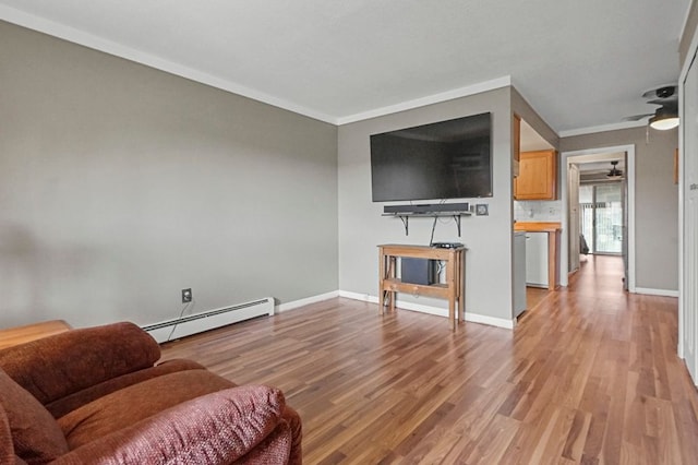 living room with a baseboard radiator, light wood-type flooring, ornamental molding, baseboards, and a ceiling fan