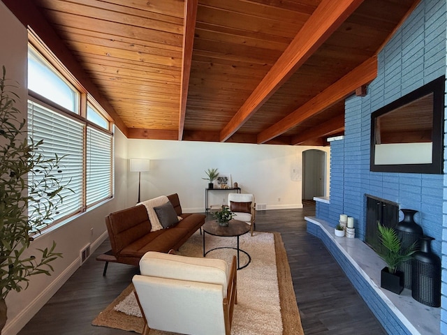 living room featuring wood finished floors, visible vents, wooden ceiling, beamed ceiling, and baseboards
