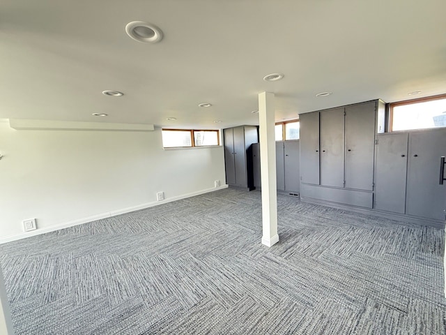 below grade area featuring baseboards, carpet flooring, visible vents, and recessed lighting