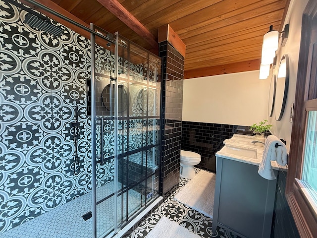 full bathroom with tiled shower, tile walls, toilet, wooden ceiling, and vanity
