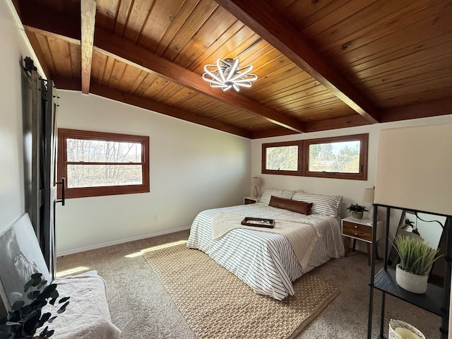 bedroom featuring a barn door, baseboards, multiple windows, and carpet