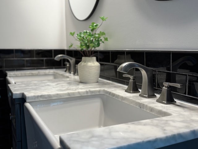 details featuring tasteful backsplash and a sink