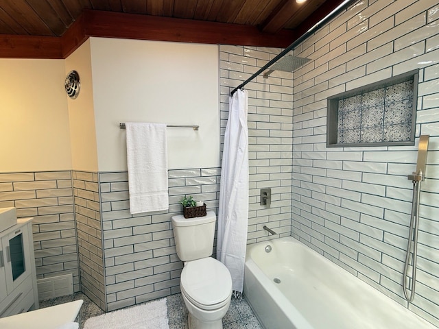 full bathroom with a wainscoted wall, toilet, tile walls, shower / tub combo with curtain, and wood ceiling