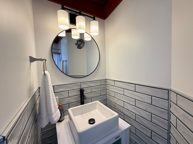 bathroom with tile walls, wainscoting, and vanity